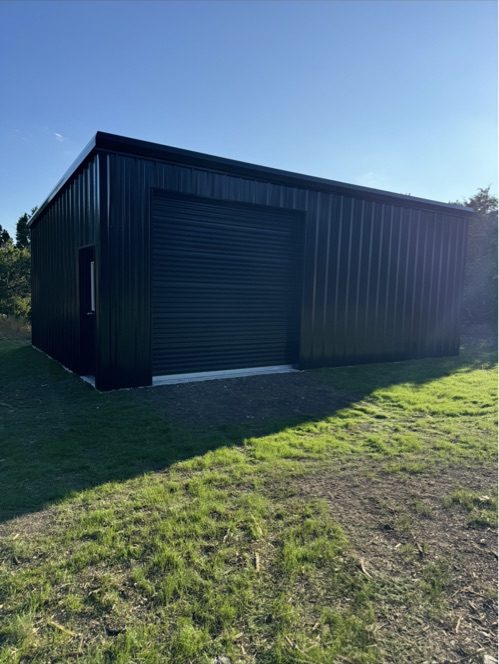 Black metal building with roll-up door, Canyon Lake area