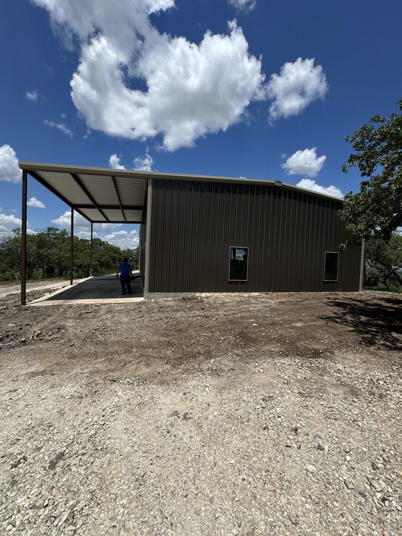 Brown steel building with covered awning, built in Central Texas
