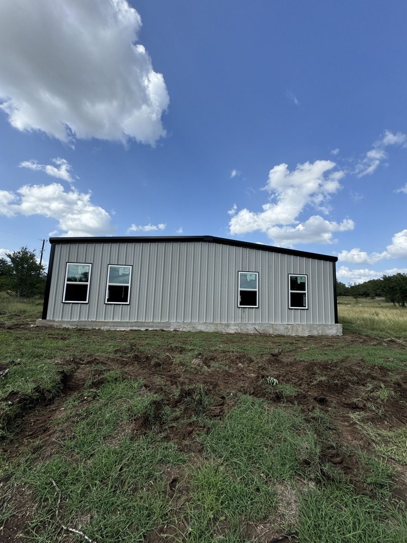 White metal building with black trim and windows, Canyon Lake area